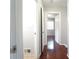 Hallway with shiny hardwood floors, white trim and gray walls, with doorway to bedroom with ceiling fan at 2020 Kenwood Se Pl, Smyrna, GA 30082