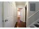 Hallway with hardwood floors, white trim and gray walls, with doorways to other rooms at 2020 Kenwood Se Pl, Smyrna, GA 30082