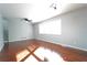 Bright room with hardwood floors, neutral walls, a ceiling fan, and a large window for natural light at 2020 Kenwood Se Pl, Smyrna, GA 30082