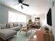 Inviting living room features a ceiling fan and large window for lots of natural light. (Virtually Staged) at 2020 Kenwood Se Pl, Smyrna, GA 30082