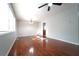 Sunlit room features hardwood flooring, neutral paint, a ceiling fan and large windows, creating an airy atmosphere at 2020 Kenwood Se Pl, Smyrna, GA 30082