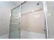 The shower-tub combination features glass doors, neutral colored tile surround, and chrome fixtures at 2020 Kenwood Se Pl, Smyrna, GA 30082