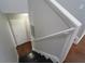 Staircase leading to the lower level with painted handrail and hardwood floors at 2020 Kenwood Se Pl, Smyrna, GA 30082