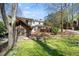Backyard showing screened porch and lush, green lawn at 2049 Castleway Ne Ln, Atlanta, GA 30345
