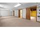 Finished basement with neutral carpet and multiple closets and doorways at 2049 Castleway Ne Ln, Atlanta, GA 30345
