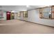 Spacious finished basement with neutral carpeting, multiple windows, and a walk-out door at 2049 Castleway Ne Ln, Atlanta, GA 30345