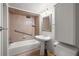 Bathroom featuring a tiled shower and tub combination with a white pedestal sink and toilet at 2049 Castleway Ne Ln, Atlanta, GA 30345