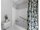 Bathroom featuring a bathtub, patterned shower curtain, white tiles, and silver hardware at 2049 Castleway Ne Ln, Atlanta, GA 30345