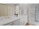 Bathroom with double vanity, white cabinets, and a shower with a blue patterned curtain at 2049 Castleway Ne Ln, Atlanta, GA 30345