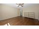Bright bedroom features hardwood floors, a ceiling fan, and a shelf at 2049 Castleway Ne Ln, Atlanta, GA 30345