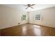 Bedroom featuring hardwood floors, two windows with shutters, and a ceiling fan at 2049 Castleway Ne Ln, Atlanta, GA 30345