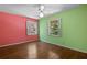 Bright bedroom features hardwood floors, two windows with white shutters, and a ceiling fan at 2049 Castleway Ne Ln, Atlanta, GA 30345