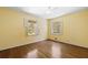 Sunny bedroom features hardwood floors, two windows with shutters, and natural light at 2049 Castleway Ne Ln, Atlanta, GA 30345