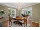 Well-lit dining room with wood floors, chandelier, and open view to the living room at 2049 Castleway Ne Ln, Atlanta, GA 30345