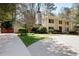 Two-story brick home with white columns, manicured lawn, and mature trees at 2049 Castleway Ne Ln, Atlanta, GA 30345
