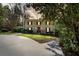 Two-story brick home with white columns, manicured lawn, and mature trees at 2049 Castleway Ne Ln, Atlanta, GA 30345