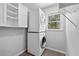 Laundry room featuring stacked washer and dryer and built-in shelving at 2049 Castleway Ne Ln, Atlanta, GA 30345