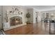 Spacious living room with fireplace, hardwood floors, and a view of the kitchen and dining area at 2049 Castleway Ne Ln, Atlanta, GA 30345