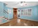Living Room featuring hardwood floors, lots of windows, a staircase, and a built-in cabinet at 2049 Castleway Ne Ln, Atlanta, GA 30345