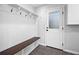 Mudroom with white paneling, built-in bench, and a glass panel door at 2049 Castleway Ne Ln, Atlanta, GA 30345