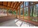 Screened porch with wood ceiling, brick base, tiled floor, and screened walls overlooking a wooded area at 2049 Castleway Ne Ln, Atlanta, GA 30345
