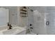 Bathroom with shower-over-tub combo, marble tile surround, and sleek black fixtures at 2546 Summer Song Way, Buford, GA 30519