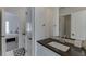 This bathroom features modern fixtures, a dark countertop, and a doorway to the bedroom at 2546 Summer Song Way, Buford, GA 30519