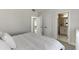 This bedroom features a neutral color scheme, soft carpet, and doorways to the ensuite bathroom and closet at 2546 Summer Song Way, Buford, GA 30519