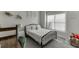 This bedroom features a stylish bed frame, a desk area, natural light, and comfortable carpeting at 2546 Summer Song Way, Buford, GA 30519