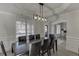 Stylish dining area highlighting a modern chandelier, wood floors, and a seamless flow to other living spaces at 2546 Summer Song Way, Buford, GA 30519