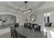 Elegant dining room featuring a modern chandelier, hardwood floors, and decorative molding at 2546 Summer Song Way, Buford, GA 30519