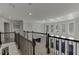 Second floor hall with wood-and-wrought-iron banister overlooks living room at 2546 Summer Song Way, Buford, GA 30519