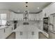 Modern kitchen features stainless steel appliances, quartz countertops, and custom cabinetry at 2546 Summer Song Way, Buford, GA 30519