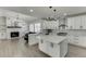 Open-concept kitchen features stainless steel appliances, custom cabinets, and a breakfast nook at 2546 Summer Song Way, Buford, GA 30519