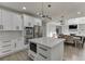 Modern kitchen boasts stainless appliances, custom cabinets, quartz countertops, and eat-in dining at 2546 Summer Song Way, Buford, GA 30519