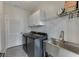 Laundry room with stainless steel sink, gray tile floor, and shelving at 2546 Summer Song Way, Buford, GA 30519