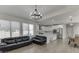 Open concept living room with modern light fixture flows into kitchen and dining area at 2546 Summer Song Way, Buford, GA 30519