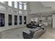 Inviting living room with large windows, wood floors, and an open layout leading to the kitchen and dining area at 2546 Summer Song Way, Buford, GA 30519