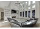 Living room features a wall of large windows, stylish lighting, and a cozy fireplace at 2546 Summer Song Way, Buford, GA 30519