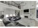 Bright living room features a fireplace, built-in shelving, hardwood floors, and elegant chandelier at 2546 Summer Song Way, Buford, GA 30519