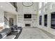 Bright living room with a grand fireplace, built-in shelves, and tall windows for plenty of natural light at 2546 Summer Song Way, Buford, GA 30519