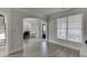 Open-concept living area with wood floors, and seamless transitions to the dining area and staircase at 2546 Summer Song Way, Buford, GA 30519