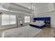 This main bedroom features hardwood floors, neutral walls, a tray ceiling, and an abundance of natural light at 2546 Summer Song Way, Buford, GA 30519
