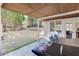 This covered patio has an outdoor dining table and a view into the backyard at 2546 Summer Song Way, Buford, GA 30519