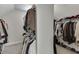 This walk-in closet has clothing on racks and carpet floors at 2546 Summer Song Way, Buford, GA 30519