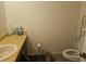Bathroom featuring a toilet, vanity, and essential cleaning supplies at 3788 Travis Trce, Decatur, GA 30032