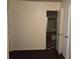 Hallway with carpet leading to a bathroom featuring checkered flooring and a sink at 3788 Travis Trce, Decatur, GA 30032