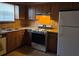 Kitchen features wood cabinets, a white refrigerator, a stove and oven range, and a double sink at 3788 Travis Trce, Decatur, GA 30032