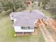 An aerial view shows the roof of a home featuring a carport and a landscaped yard at 1202 Coan Dr, Locust Grove, GA 30248