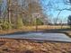Outdoor asphalt basketball court with a hoop and expansive green space at 1202 Coan Dr, Locust Grove, GA 30248